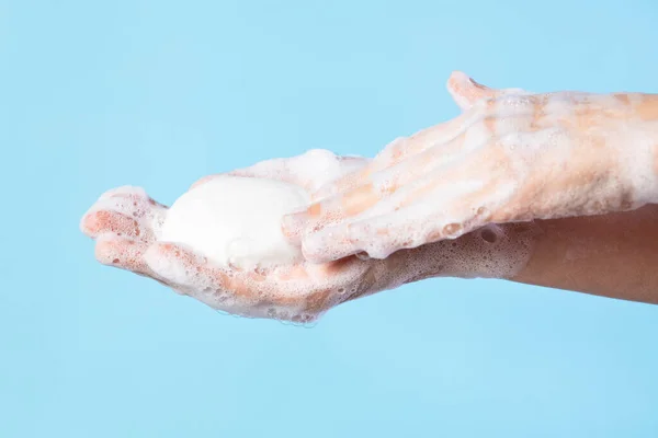 Woman washing hands with soap. Closeup of female washing hands isolated