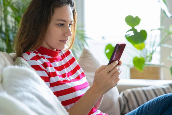 Young Woman Using Mobile Phone While Sitting Sofa Home — Stock Photo, Image