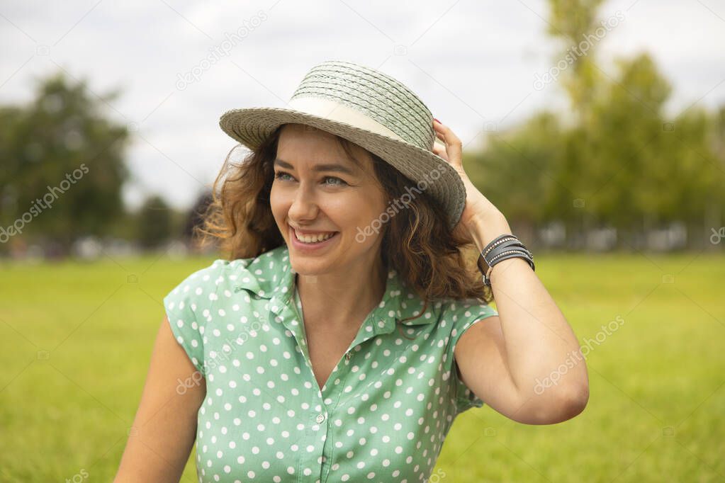 Portrait of young brunette woman having fun in the park