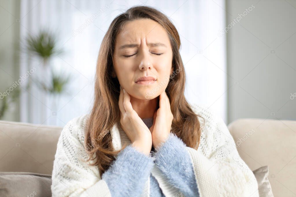 Young woman touching painful neck, sore throat for flu, cold and infection