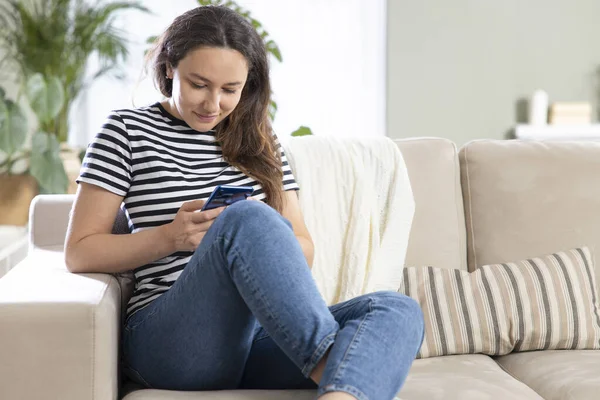 Young Woman Using Mobile Phone While Sitting Sofa Home — Stock Photo, Image