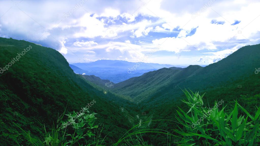 Mountain Landscape of View on road to Da Lat, Vietnam. Beautiful peaceful nature background for restore meditation, relaxation, card. Green & blue mountains at serene highlands of South East Asia. 