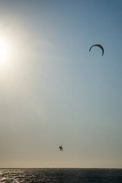 kite surfer catching air in the sea