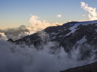 Alpine peaks in the clouds seen from Mantova hut on Monte Rosa,  clipart