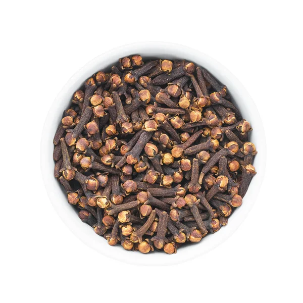 Dried spice cloves in round bowl isolated over white background. — Stock Photo, Image
