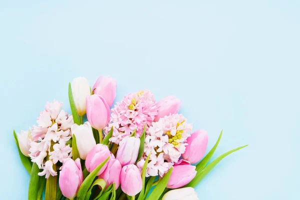 Pink tulips and pink hyacinths flowers on a light blue background. Top view, copy space — Stock Photo, Image