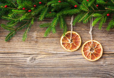 Christmas background. Christmas fir tree and orange on old wooden board background, copy space