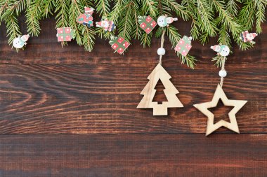 Christmas wooden background with star and decorated Christmas tree. New year. Copy space