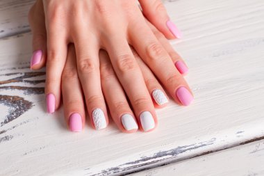 White-pink manicure with ornaments.  clipart