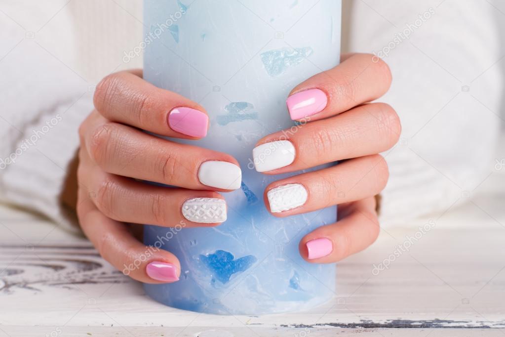 Delicate white-pink female manicure. 