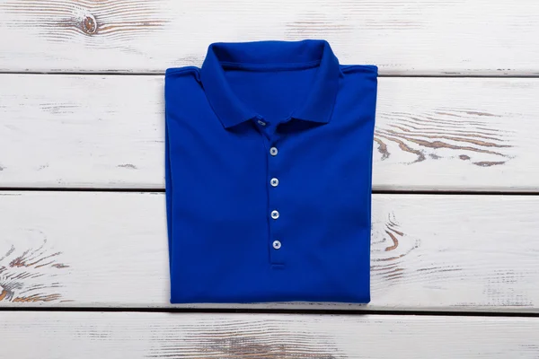 Blue folded polo t-shirt.