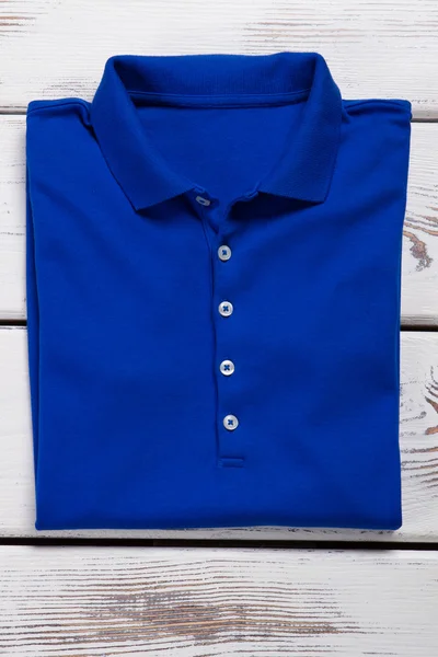 Blue folded t-shirt with collar.