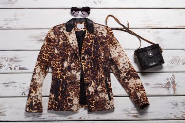Leopard blazer and black purse. clipart