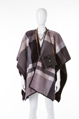 White mannequin in poncho.