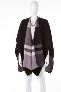 Poncho on white mannequin.