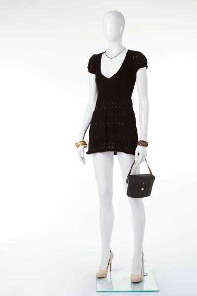Black retro handbag on mannequin.