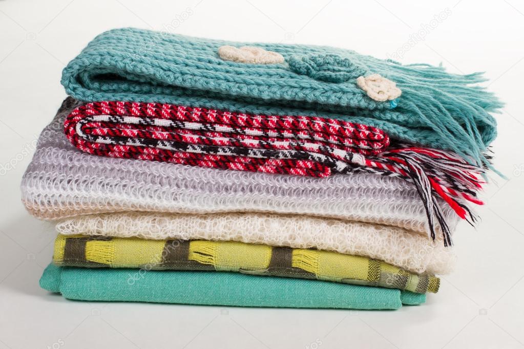 Stack of different winter scarves. 