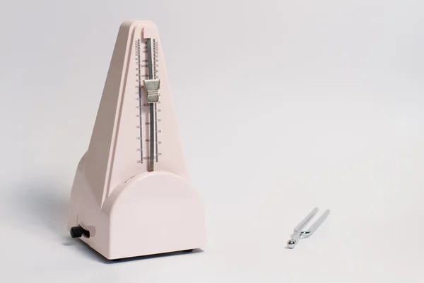 Music pitchfork and metronome — Stock Photo, Image