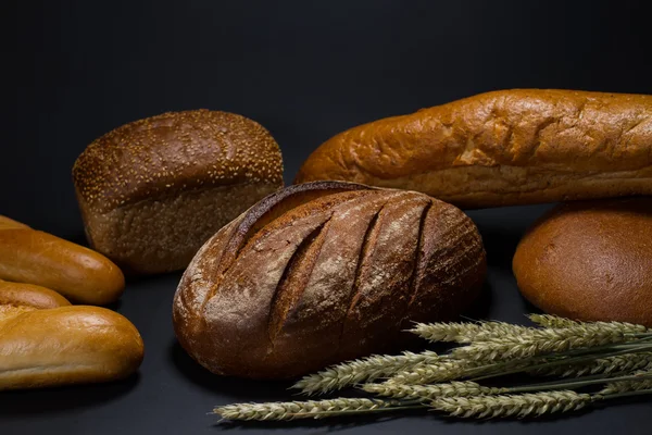 Bread on black background — Stock Photo, Image