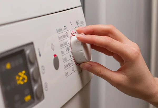 Selecting a program for washing laundry. — Stock Photo, Image