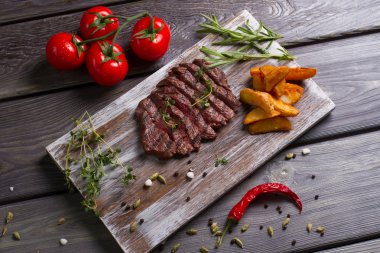  Meat and rosemary on wooden background.