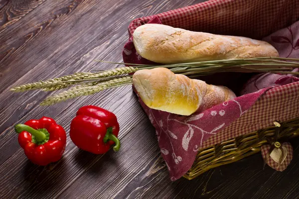 Paprika and bread basket on wooden background. — ストック写真