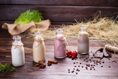 Natural milkshakes on the background of hay and sackcloth.