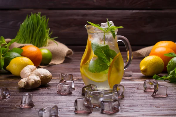 Citrusy lemonade in jug with ice. — Stock Photo, Image