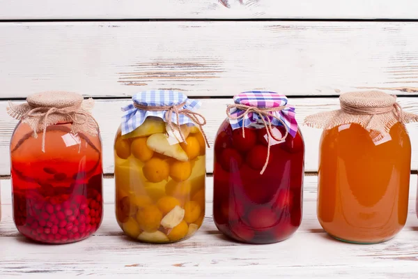 Canned compotes in large glass jars. — Stock Photo, Image