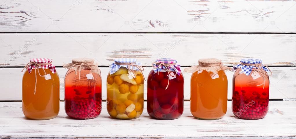 Canned fruit drinks in glass jars.