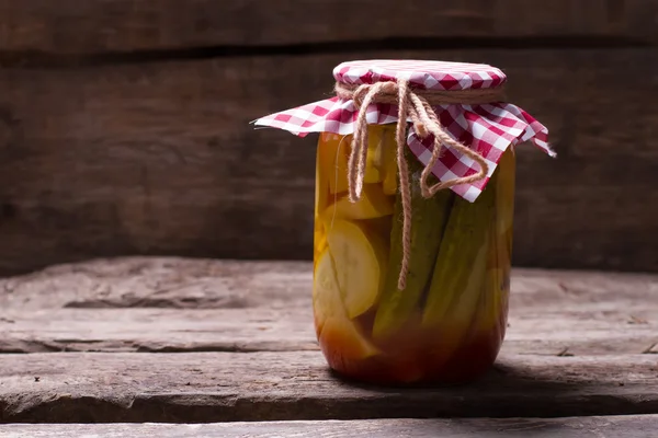 Pickled cucumbers with zucchini in the glass jar. — Stock Photo, Image