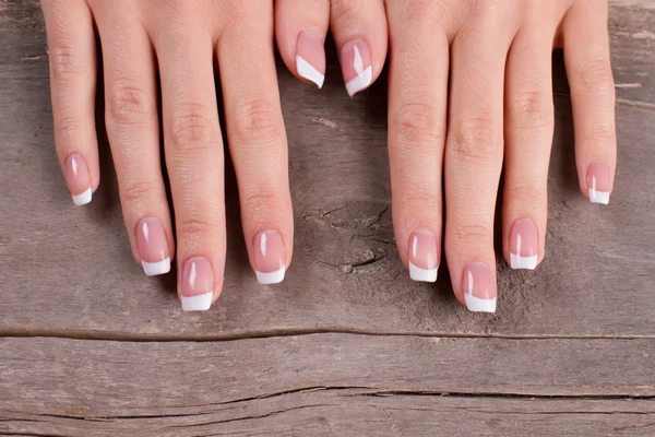 Gentle french manicure on vintage board. — Stock Photo, Image