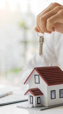 Bir emlakçı müşterilerine gayrimenkul satın almalarını ya da kiralamalarını tavsiye eder..