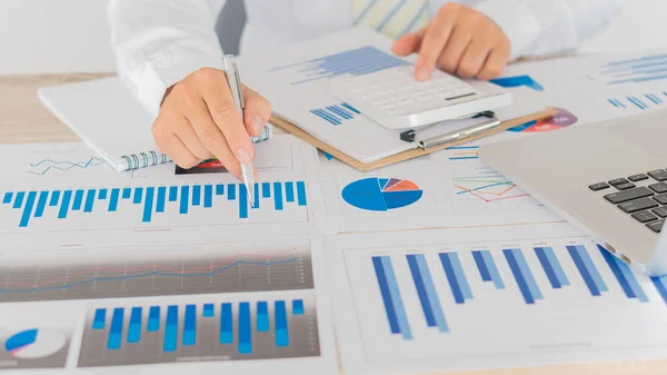 Businessman analyzes graphs calculations on the concept of financial accounting.
