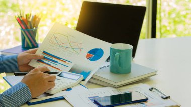 Ofiste zaman geçirirken bilgisayar kullanarak veri analizi yapan kendinden emin genç bir işadamı..