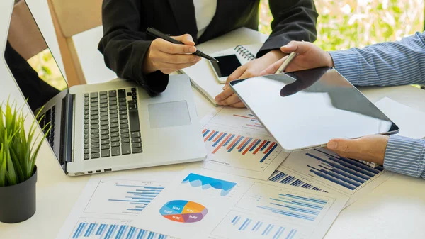 Business people doing business in finance and calculating, analyzing, graphing the cost of investments, real estate and more. Tax system on the desk with laptop on the table in the home office.