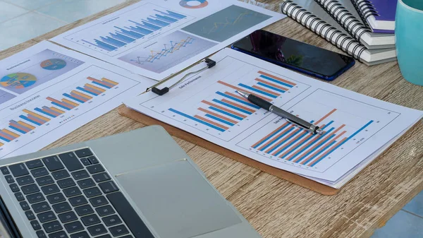 Business people doing business in finance and calculating, analyzing, graphing the cost of investments, real estate and more. Tax system on the desk with laptop on the table in the home office.