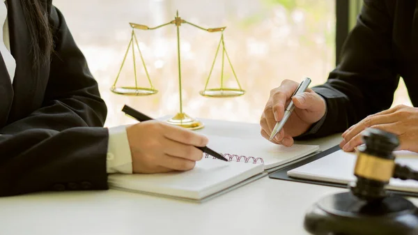 Businesswoman, lawyer consultant in office with forward-placed judge hammer and justice scales with laptop, attorney concept and legal adviser.