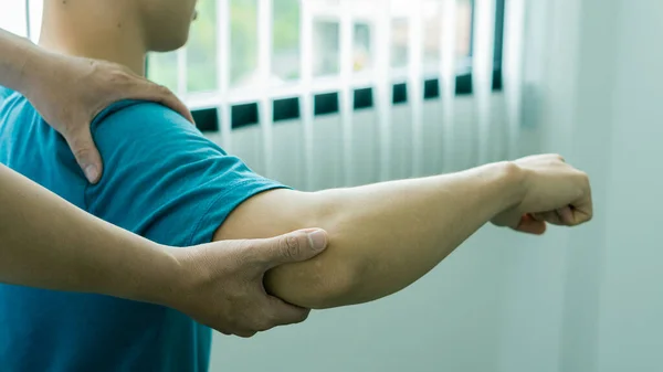 Man with shoulder pain and doctor giving massage medical concept Health care and physical therapy