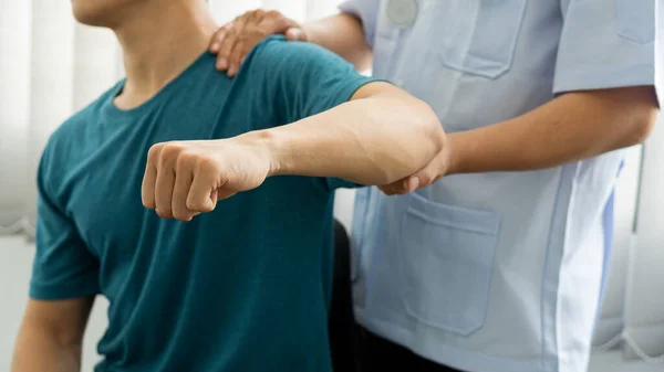 Man with shoulder pain and doctor giving massage medical concept Health care and physical therapy