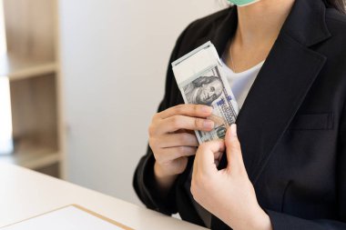 Birçok iş adamının elindeki Amerikan doları banknotları, başarılı iş ve zenginlik. Finans ve harcama konseptiyle