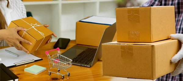 Starting a Small BusinessEntrepreneurship Asian SME work with boxes and laptops to take orders. At home, office, warehouse, online marketing package delivery, SME e-commerce concept.