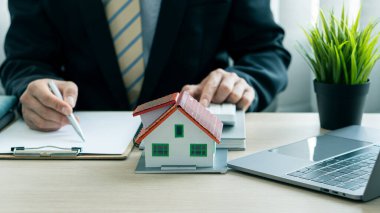 Satış temsilcileri resepsiyonda ev satın alma sözleşmeleri veya ofis kredileri ve faiz oranlarıyla çalışırlar.