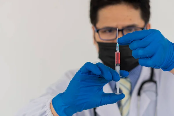 Doctor's hand holding a bottle of vaccine and needles for vaccinating patients Coronavirus injection process. Doctors order injections to create antibodies against corona virus covid 19