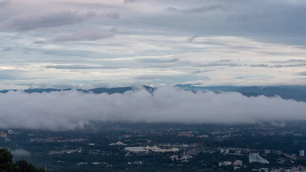 A view from a high point overlooking the clouds and the belly of Chiang Mai, Thailand.