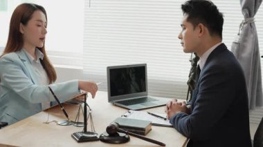 Hukuk ve adalet kavramı: Avukat genç kadın avukatlara hukuki danışmanlık yapar, yasal belgeleri tartışır ve önemli davalarda rehberlik eder.