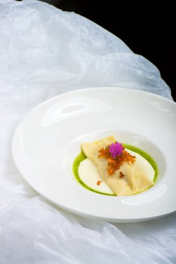 İyi yemek, dev ravioli, keçi peyniri ve kızarmış soğanla dolu.