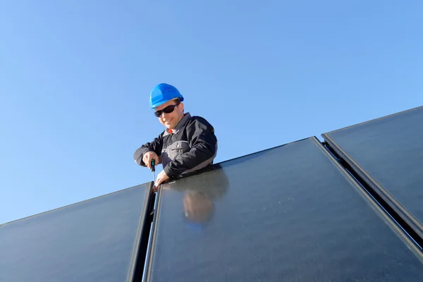 Человек устанавливает солнечные панели — стоковое фото
