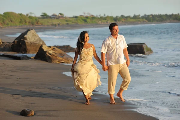 Bride and groom against the blue ocean — Stock Photo, Image