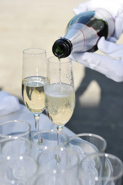 De ober schenkt champagne in. — Stockfoto